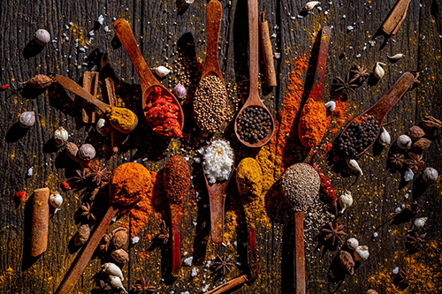 Aromatic Spice Symphony: A captivating still life of vibrant spices scattered across rustic